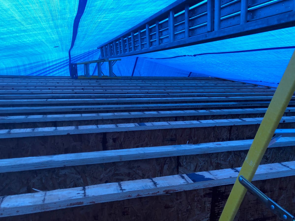 New floor framing under weather tarps